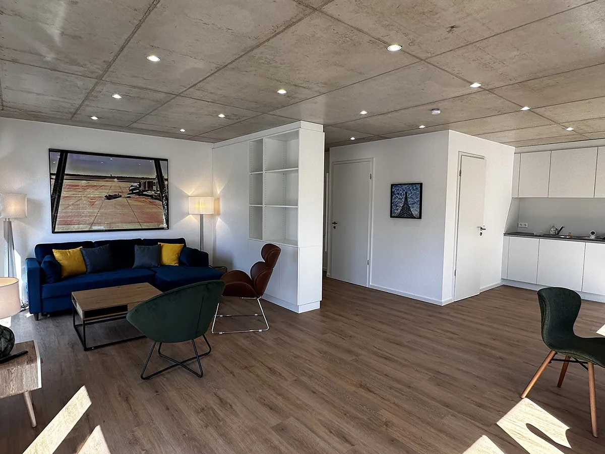 Living room with view of the lounge area and kitchen.