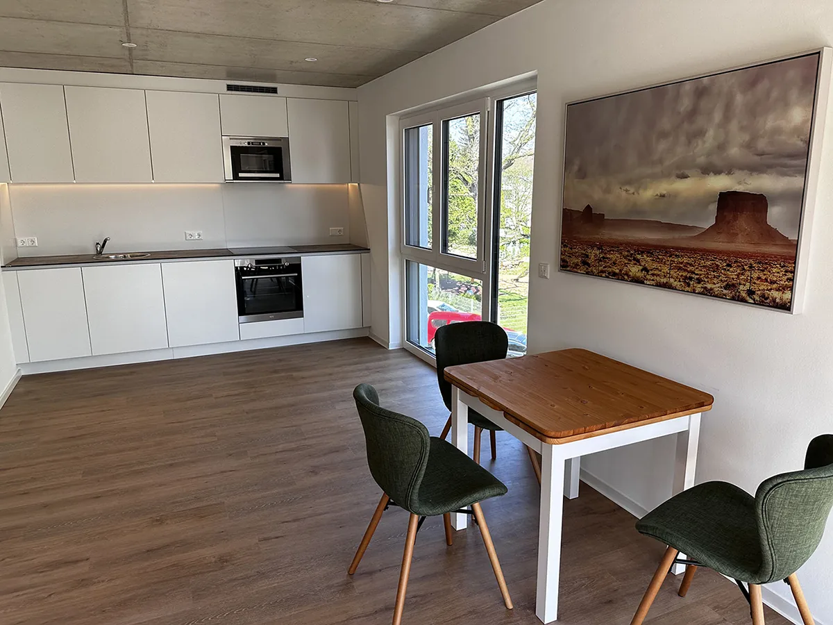 Kitchen area with ceramic hob and microwave oven.