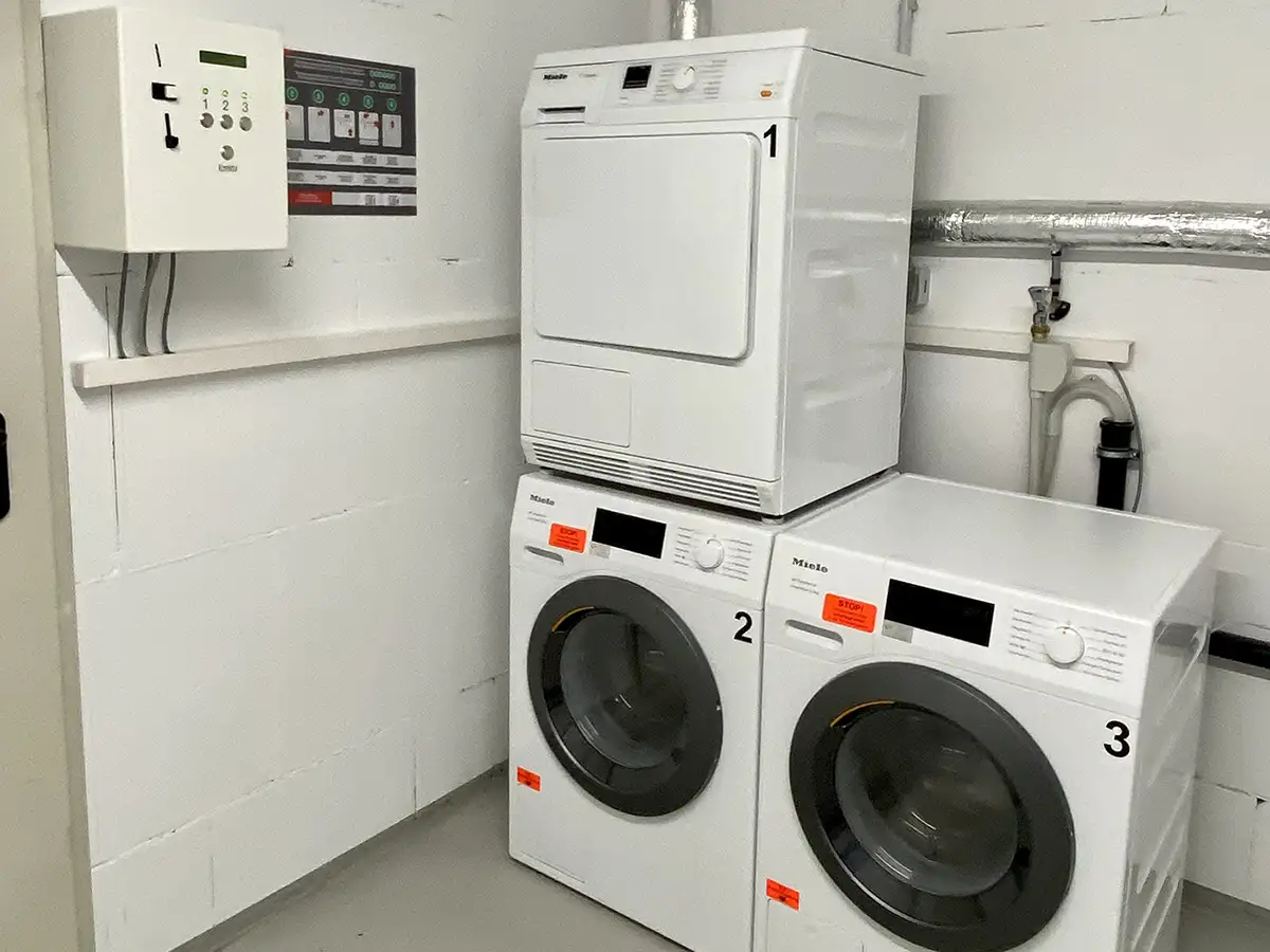 Laundry room with washing machines and dryer